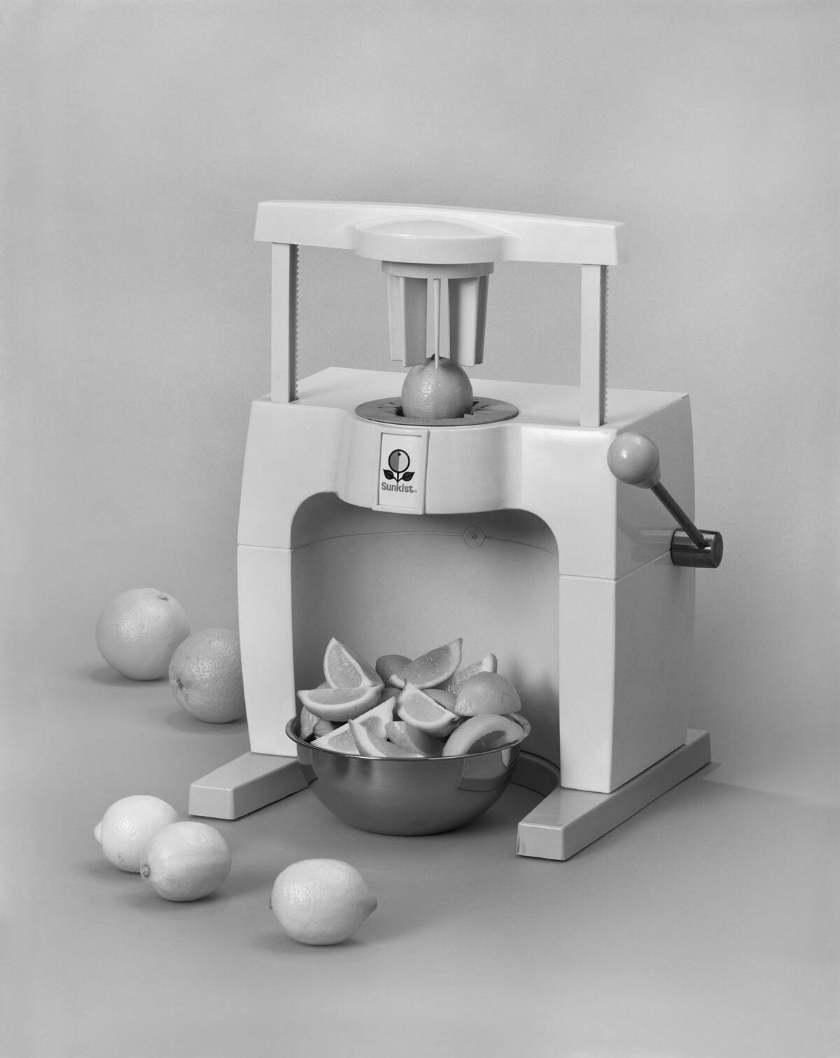 Juice extractor with citrus fruits against white background