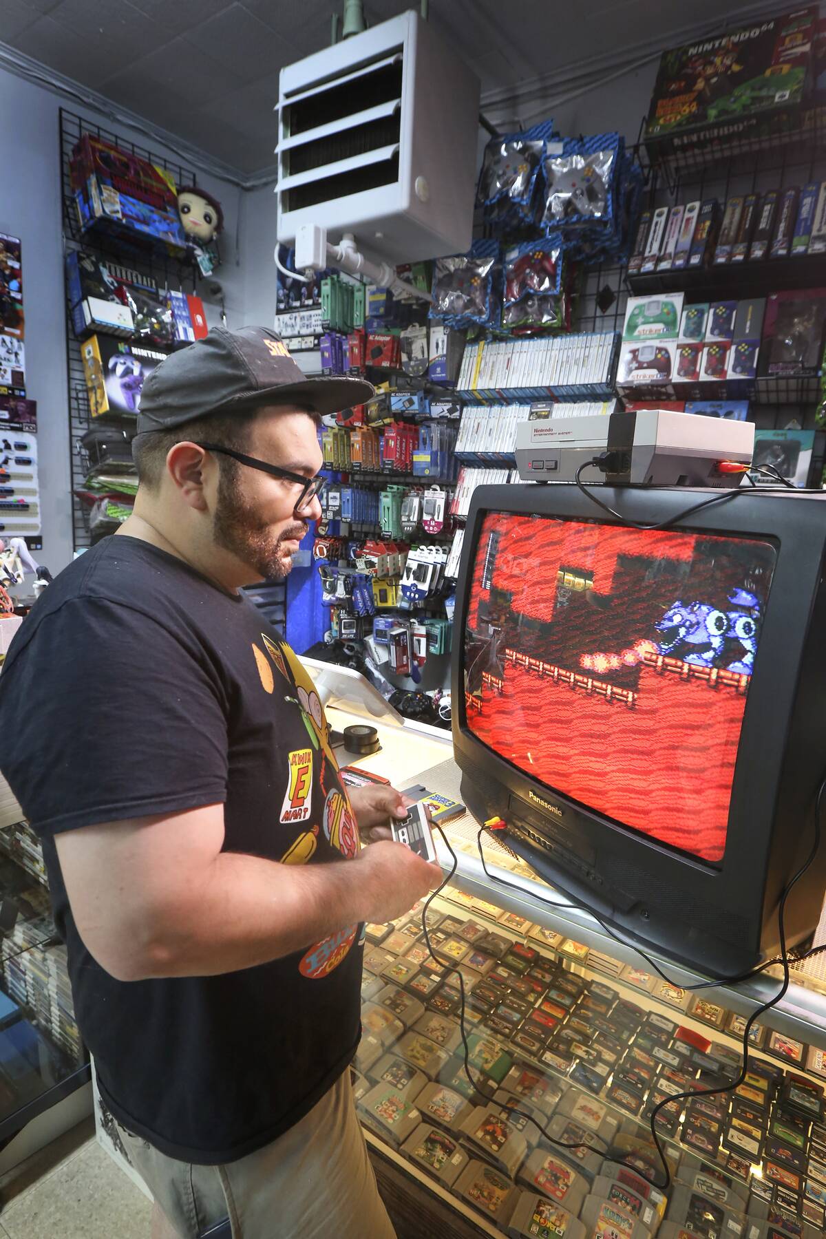 Long Island gaming store owner plays video game