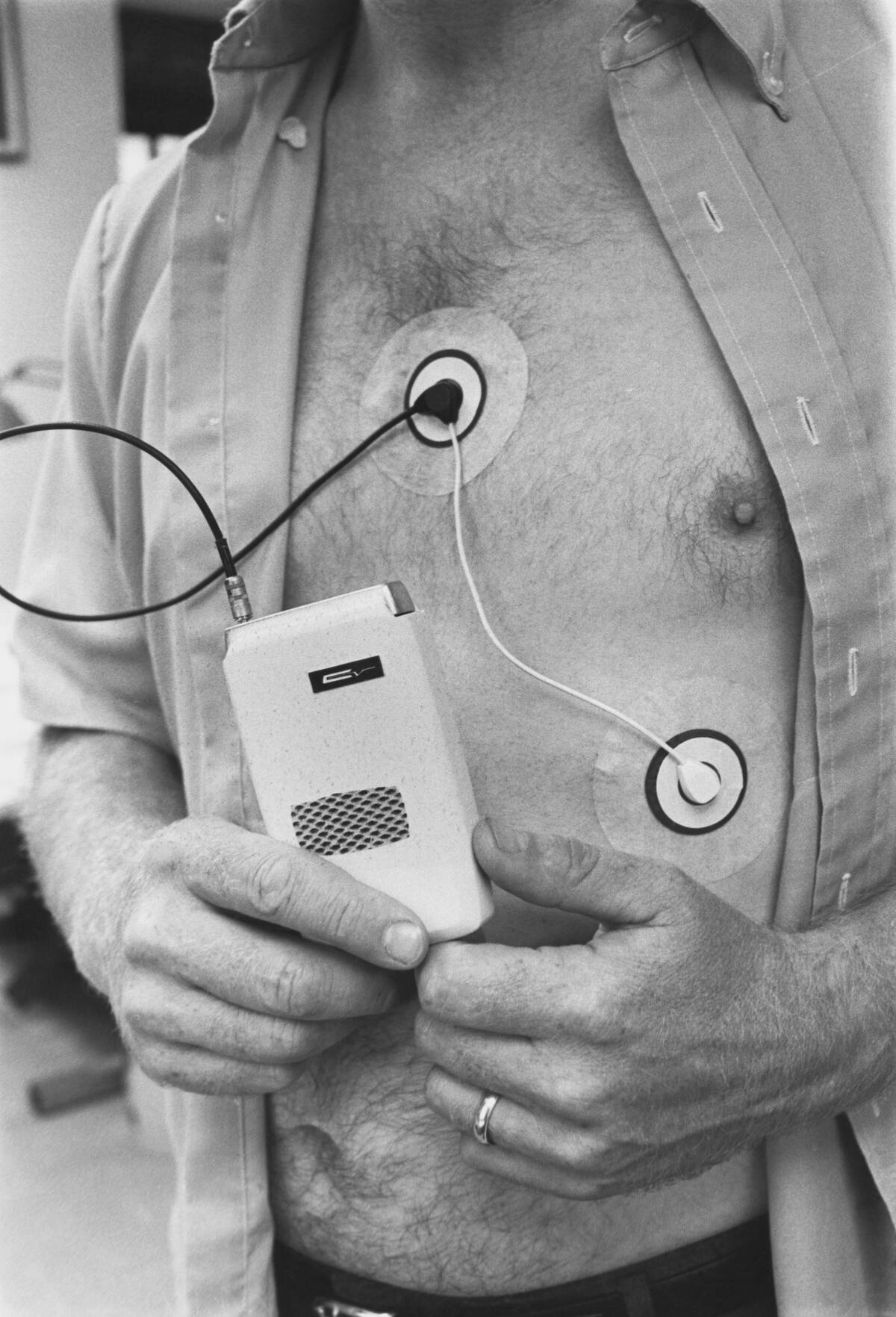 Man Attached and Holding to Medical Device