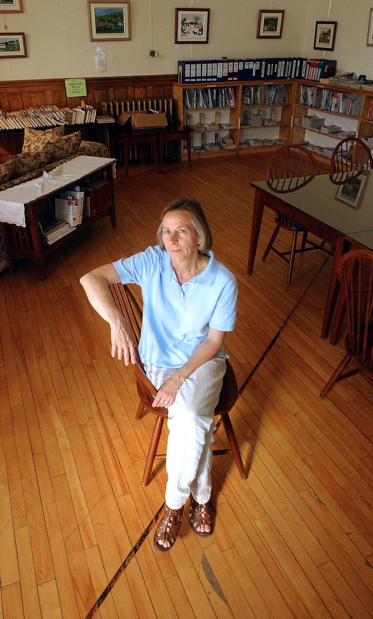 Mary Roy poses in the Haskell Free Library, which straddles