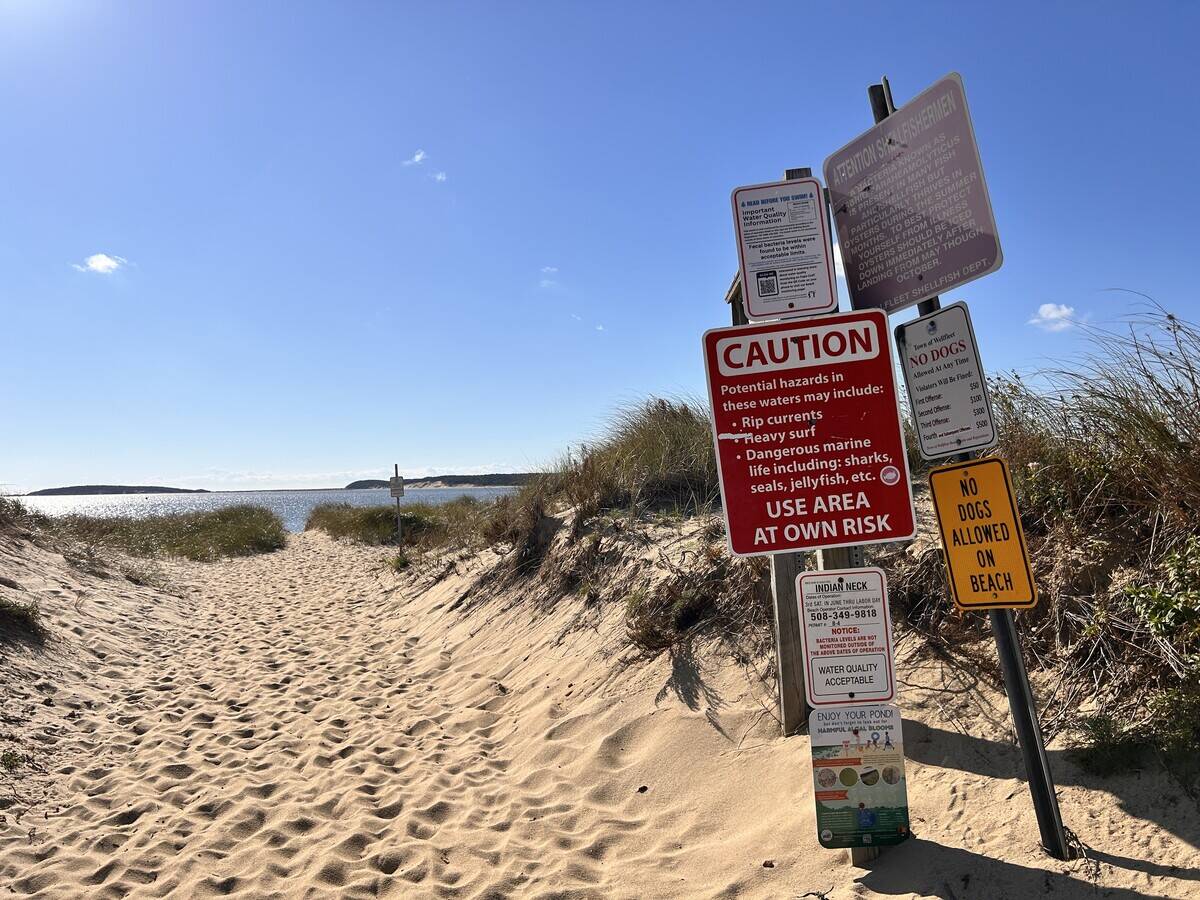 Multiple warning signs and rules at entrance to beach at Indian Neck, Wellfleet, Cape Cod, Massachusetts