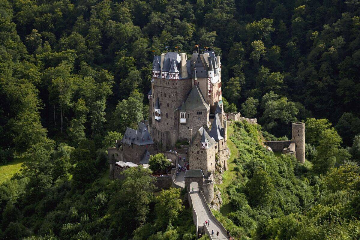 Pedestrians walking up road to Eltz castle