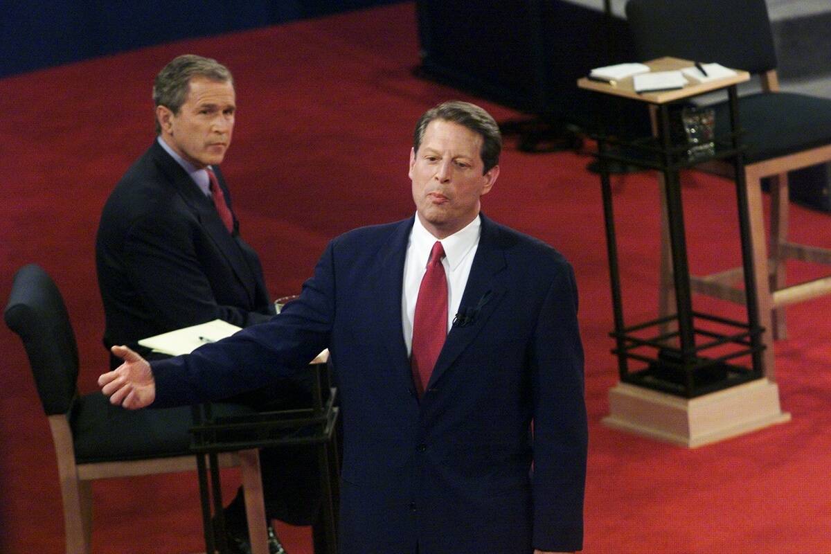 Texas Gov. George W. Bush looks on as Vice President Al Gore