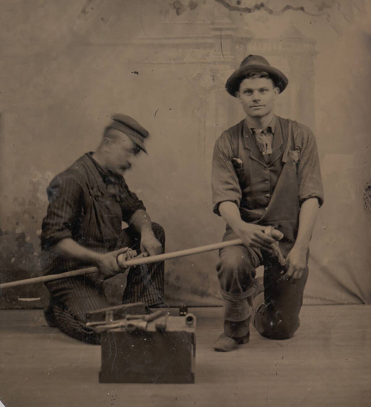 Two Plumbers With A Pipe