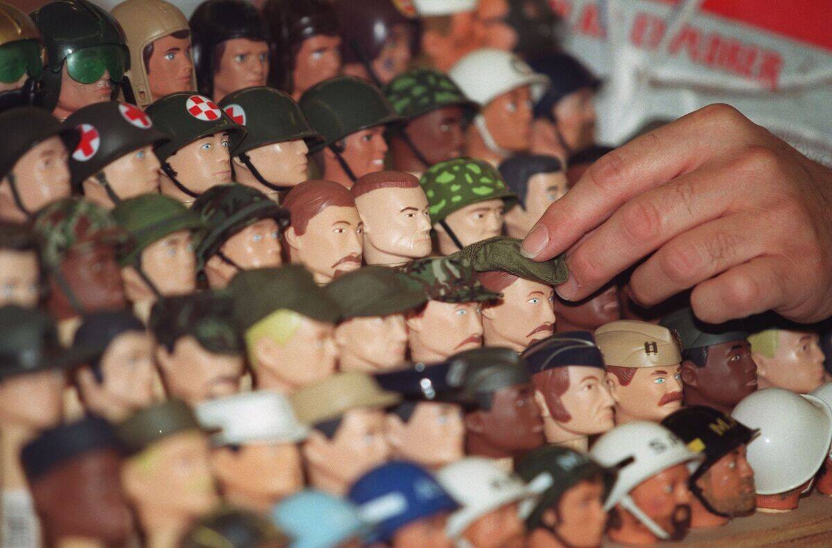 Vendors position heads of dolls prior to the openi