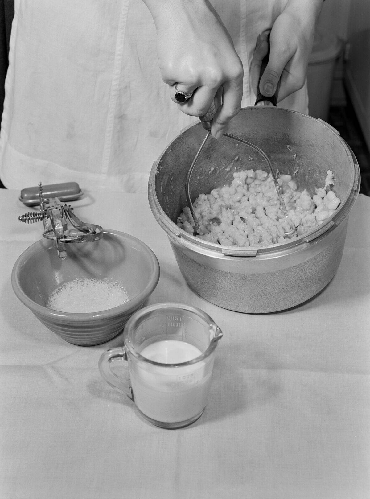 Woman Mashing Cooked Beans while Making Baked Bean Loaf, Meat Substitute, October 1942