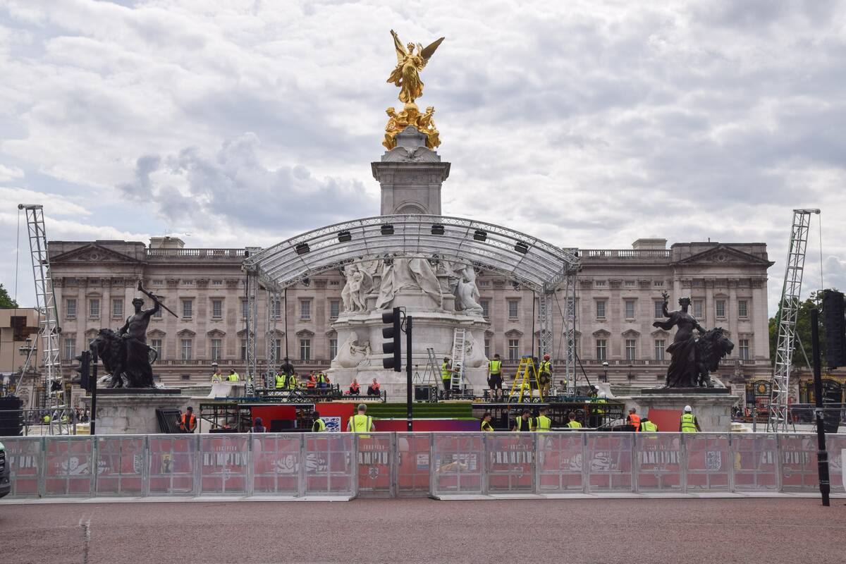 Workers build the stage at the Victoria Memorial ahead of...