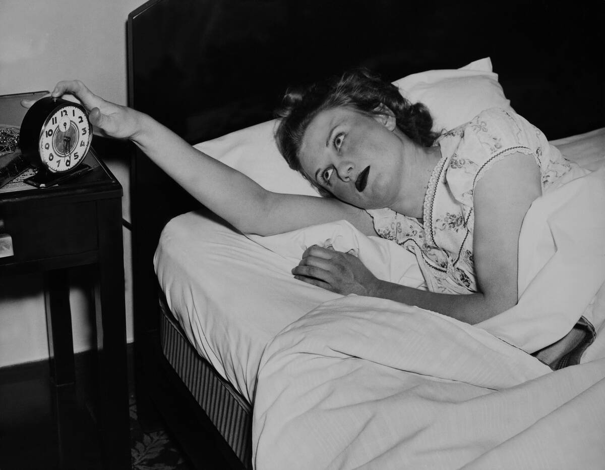 Young Girl Awaked By The Alarm Clock.