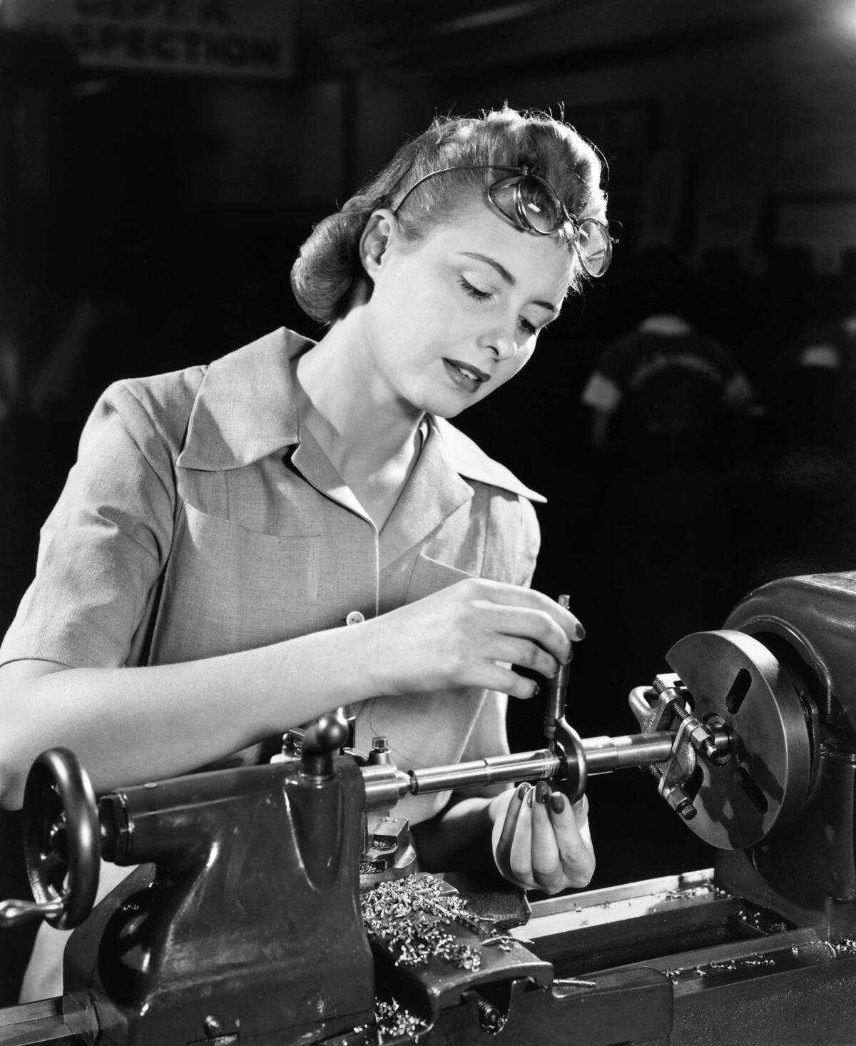 1940s WOMAN WORKING IN...