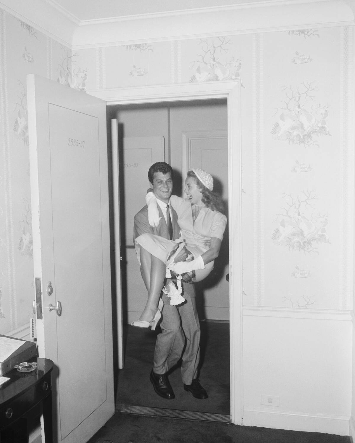 Actor Tony Curtis Carrying Wife Janet Leigh