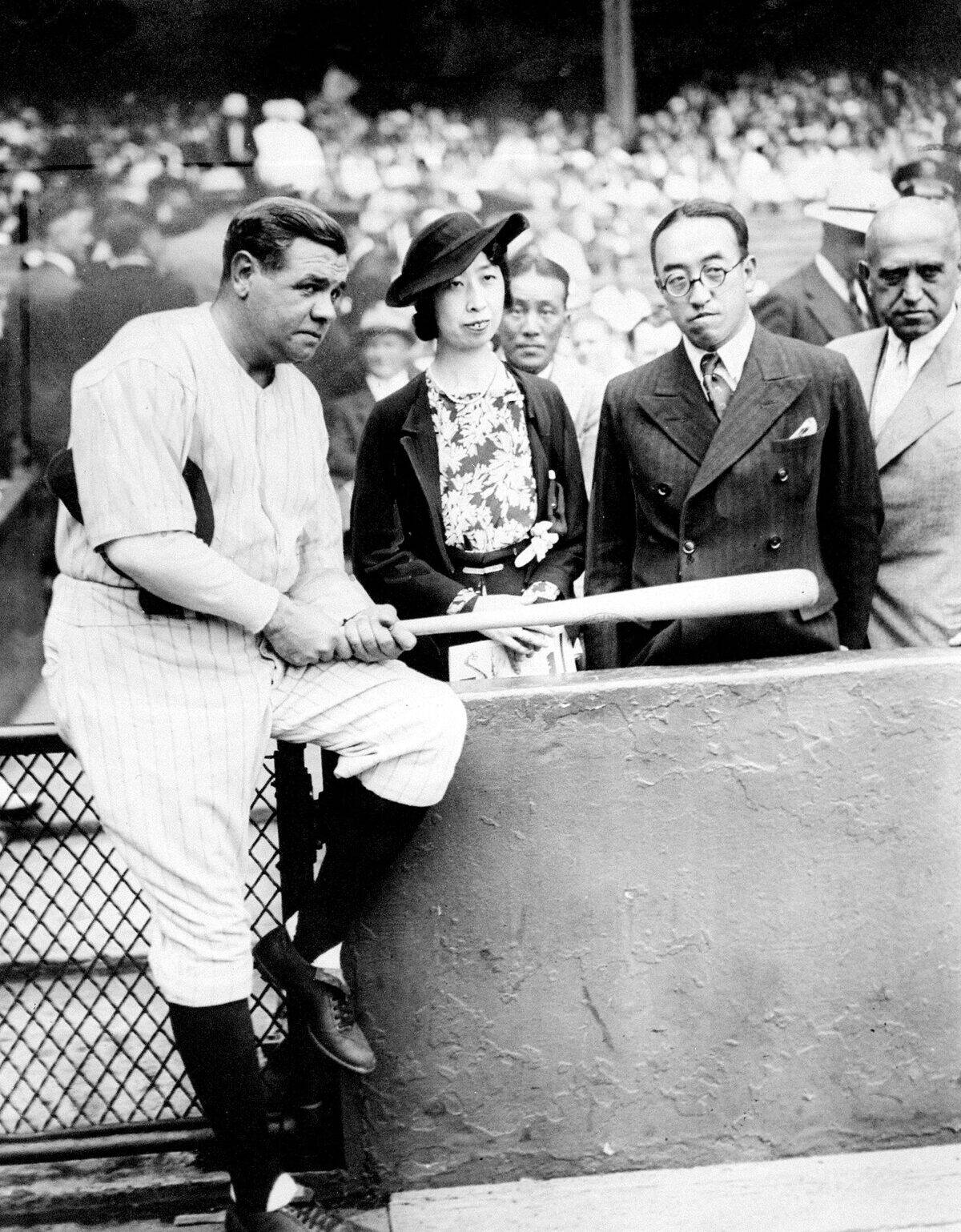 Babe Ruth holds autographed bat for Prince and Princess Kaya