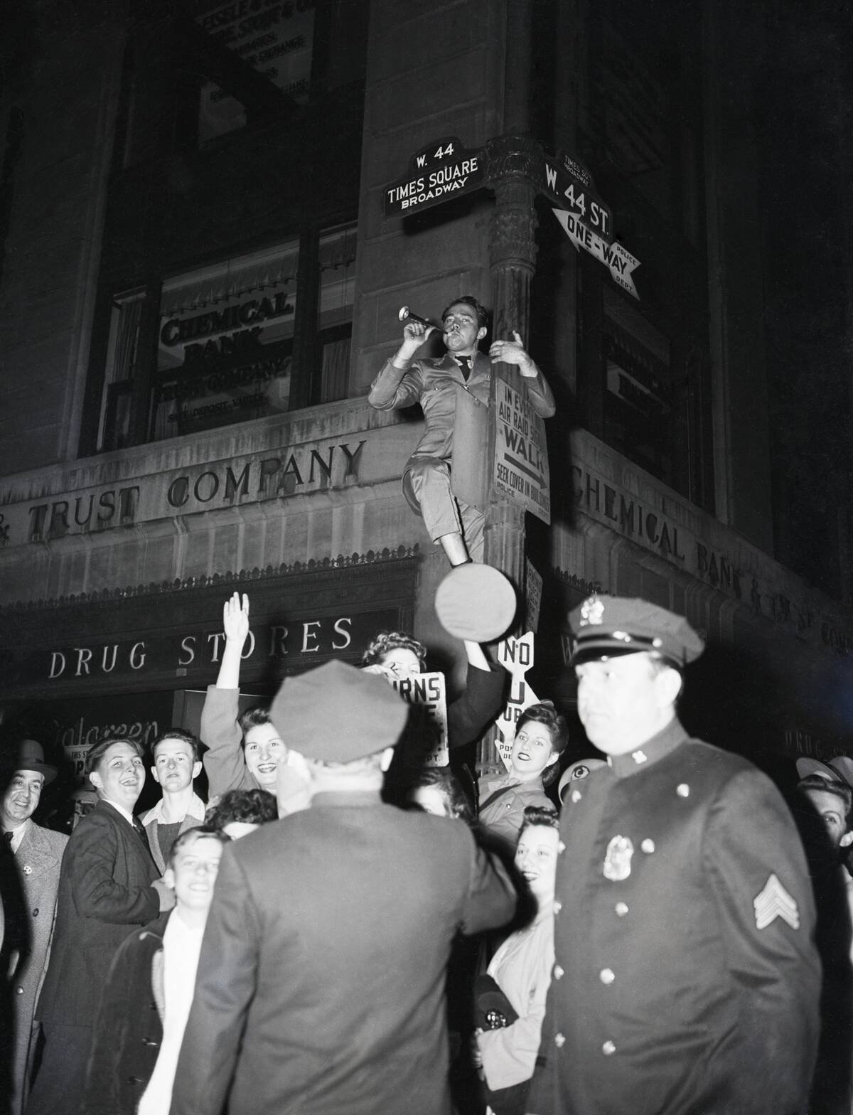Celebration Of V-E Day;Man On Signpost