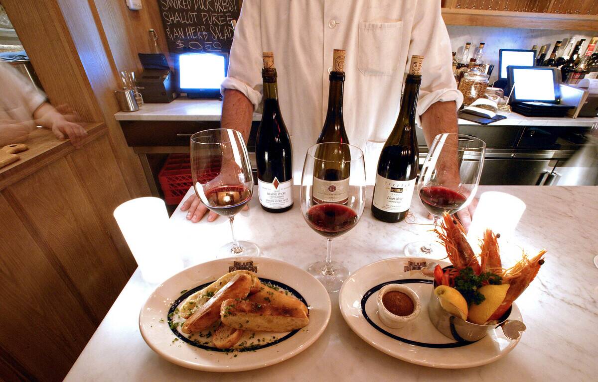Chef Sefton Stallard poses with a wine flight, rear, grilled