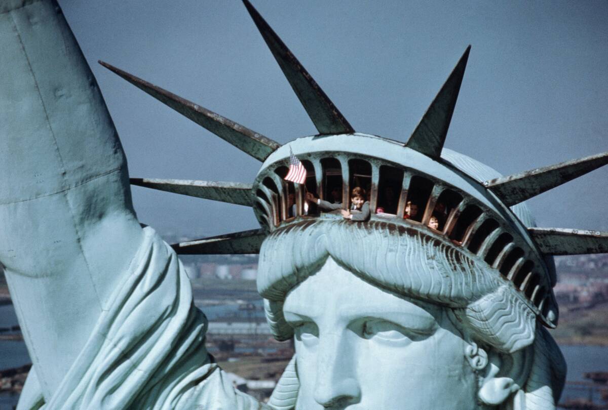 Child Waving Flag from the Crown of the Statue of Liberty