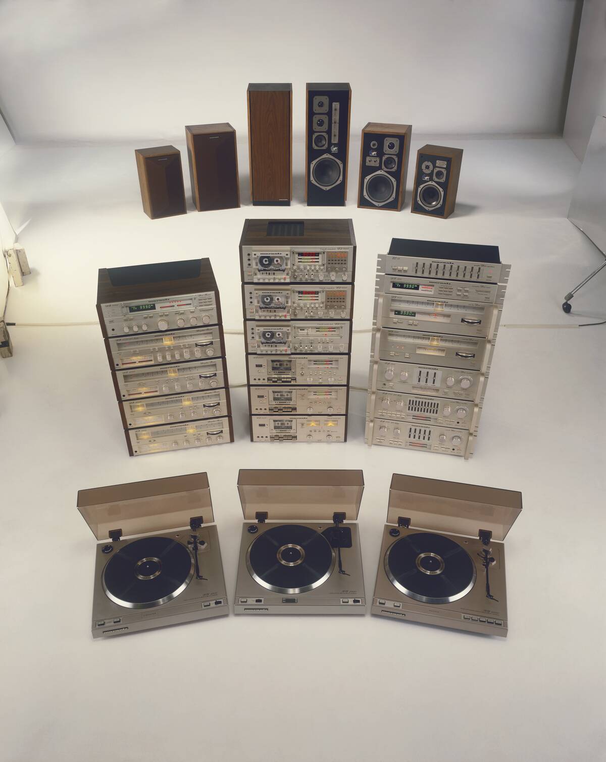 Compact disk, loudspeakers and stereos on white background
