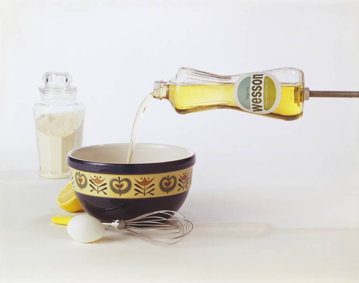 Cooking oil being poured into bowl, close-up