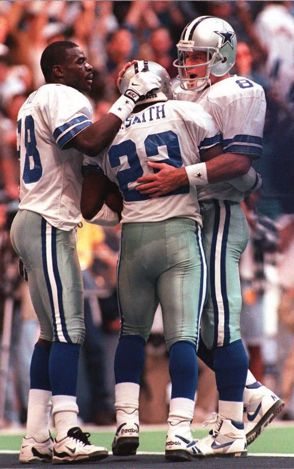 Dallas Cowboys quarterback Troy Aikman (R) and wid