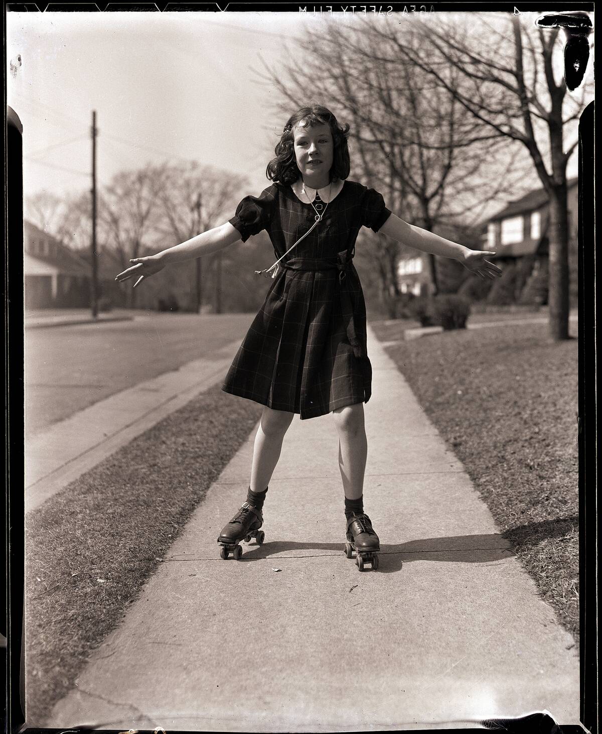 Girl Roller Skating on Sidewalk