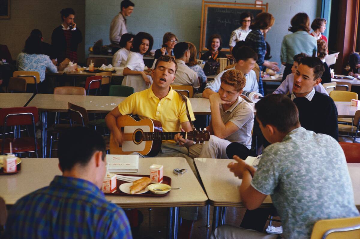 High School Kid Playing a Guitar and Singing