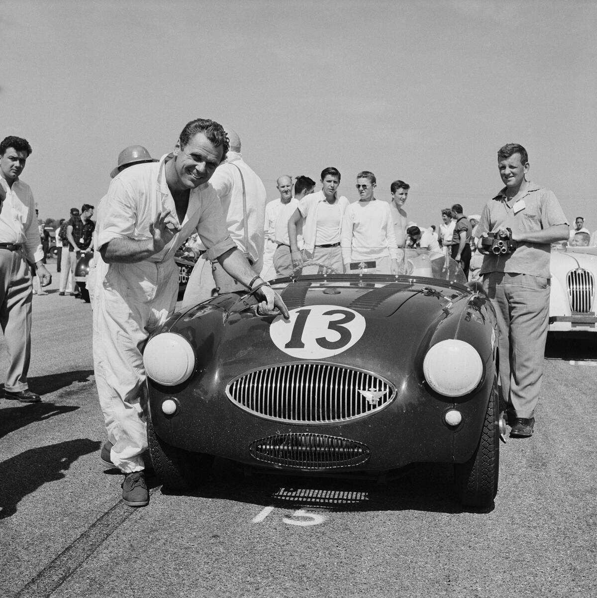 Jackie Cooper Pointing Number 13 on Sports Car