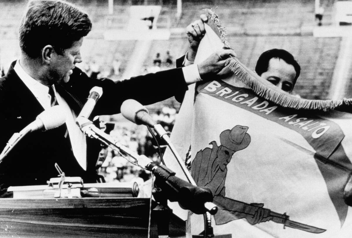 Kennedy Holding Flag of Cuban Exiles