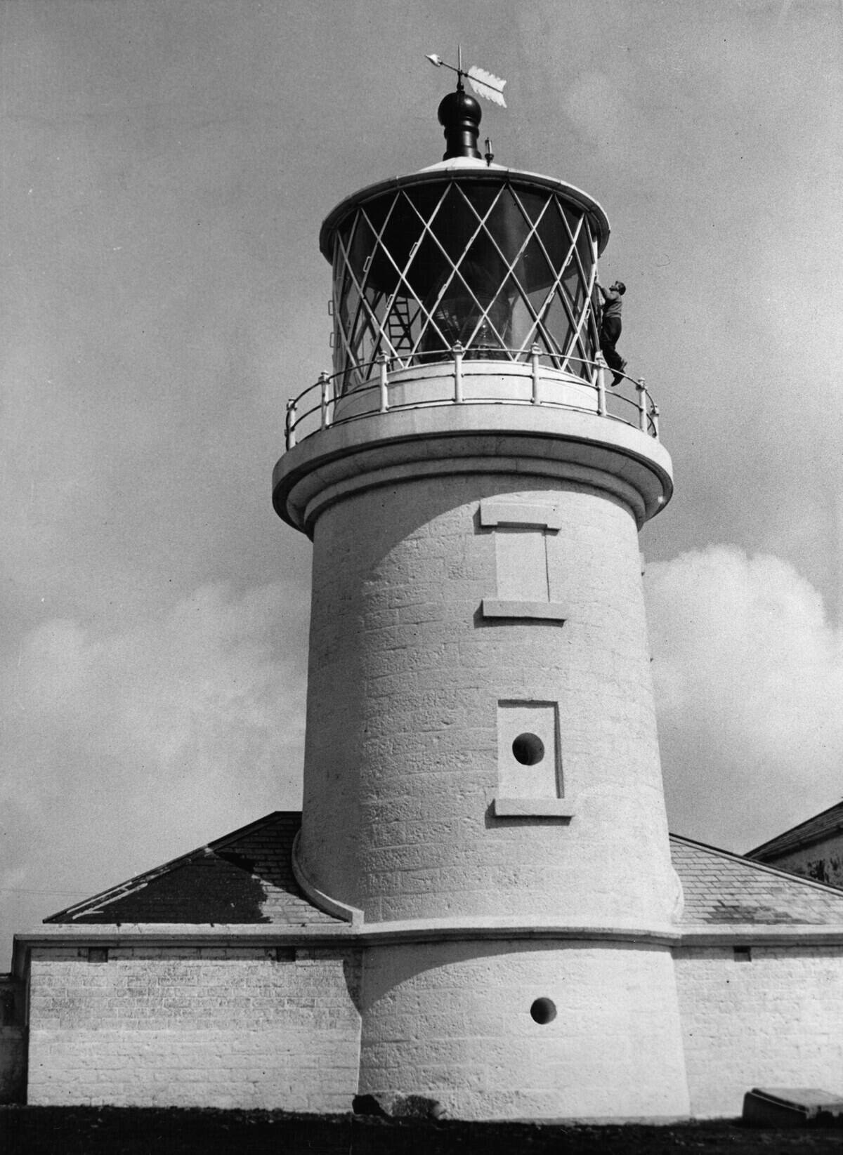 Lighthouse on the island Caldey, Wales being cleaned by the lighthouse keeper, Photograph, England, April 28th 1936