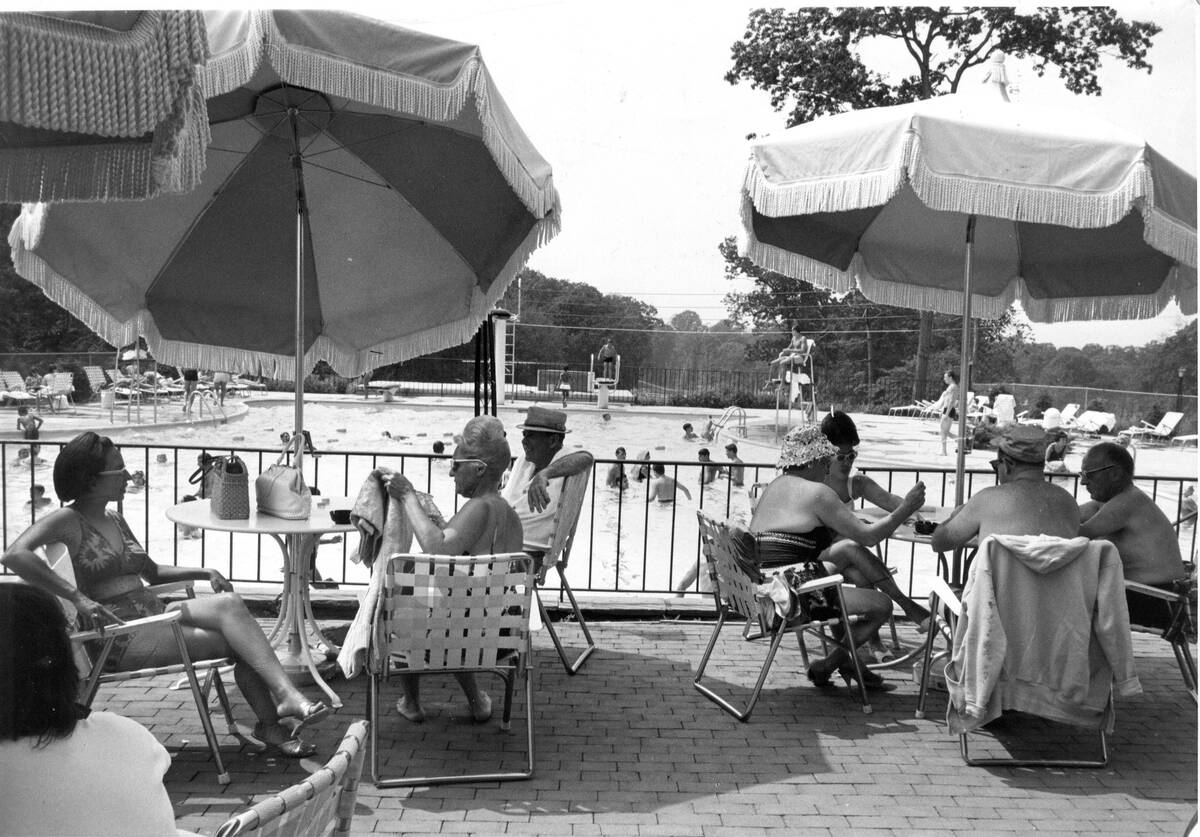 Long Island country club members sit near pool in 1963