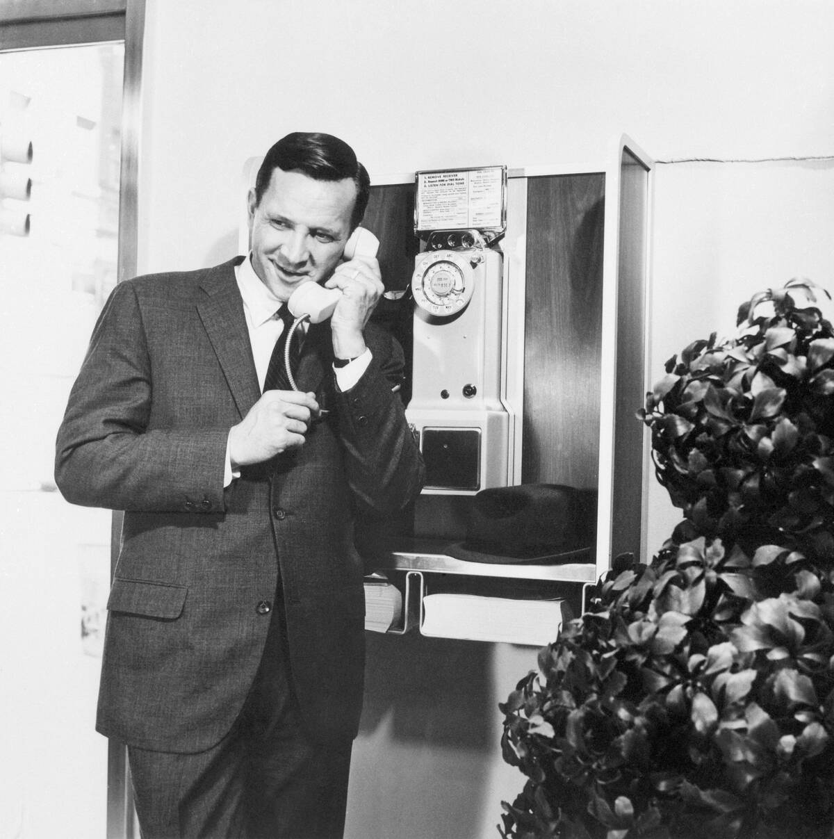 Man Using a Public Pay Telephone in Booth