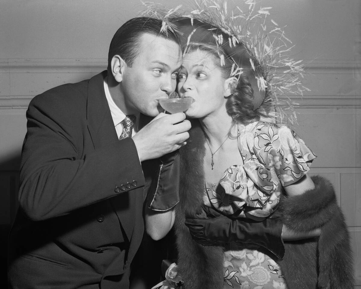 Man, Woman Drink Champagne From One Glass
