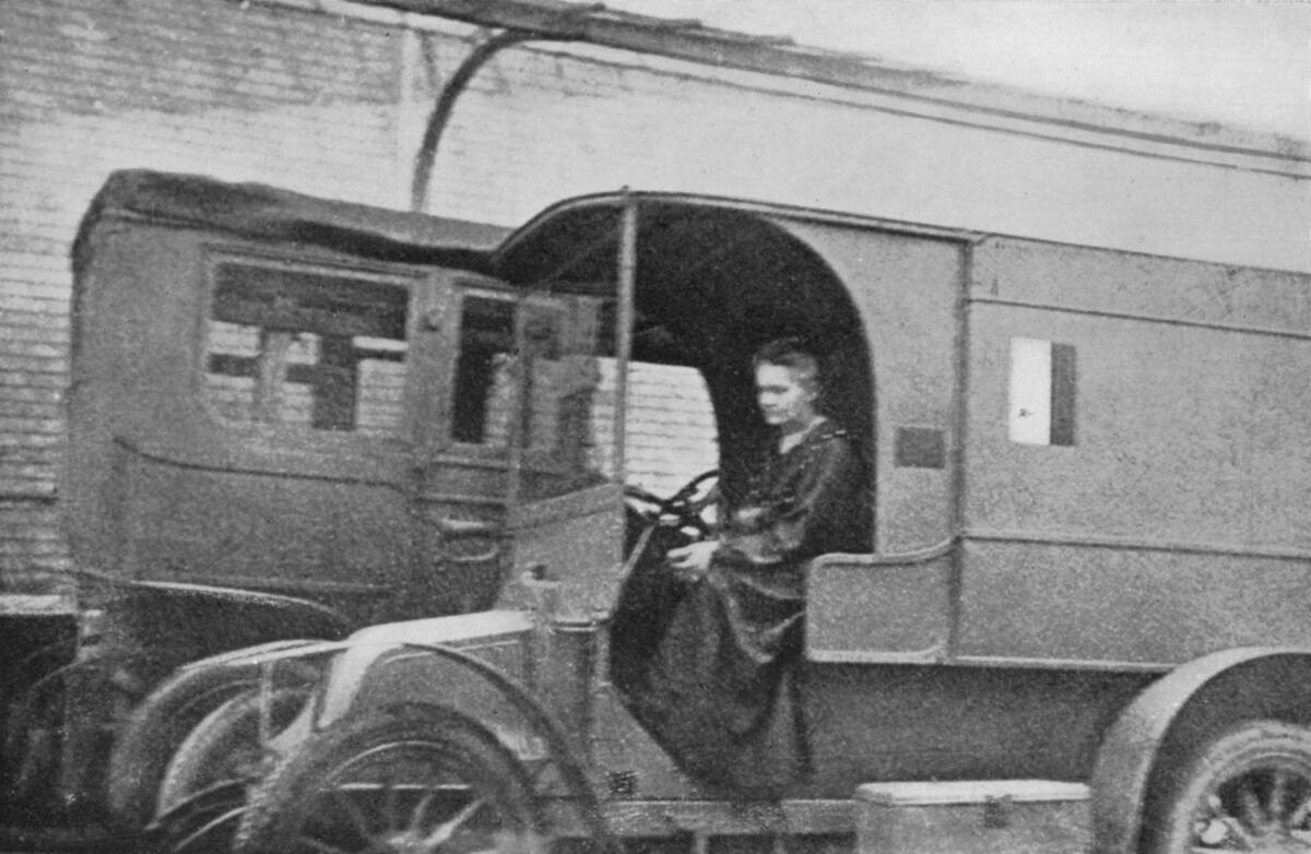 Marie Curie, Polish-born French physicist, driving a car converted into a radiological unit, 1914.