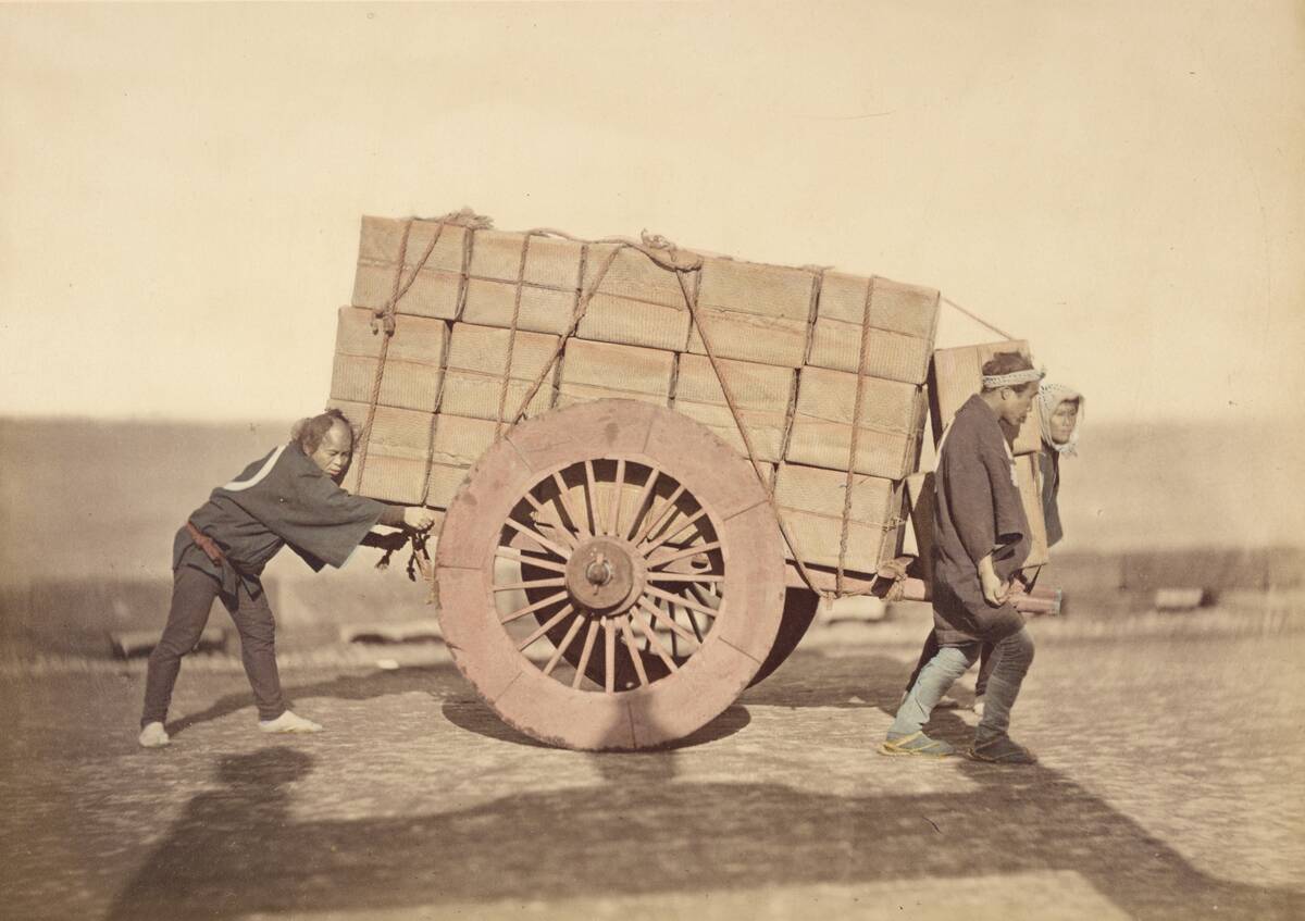 Men Pushing A Wagon