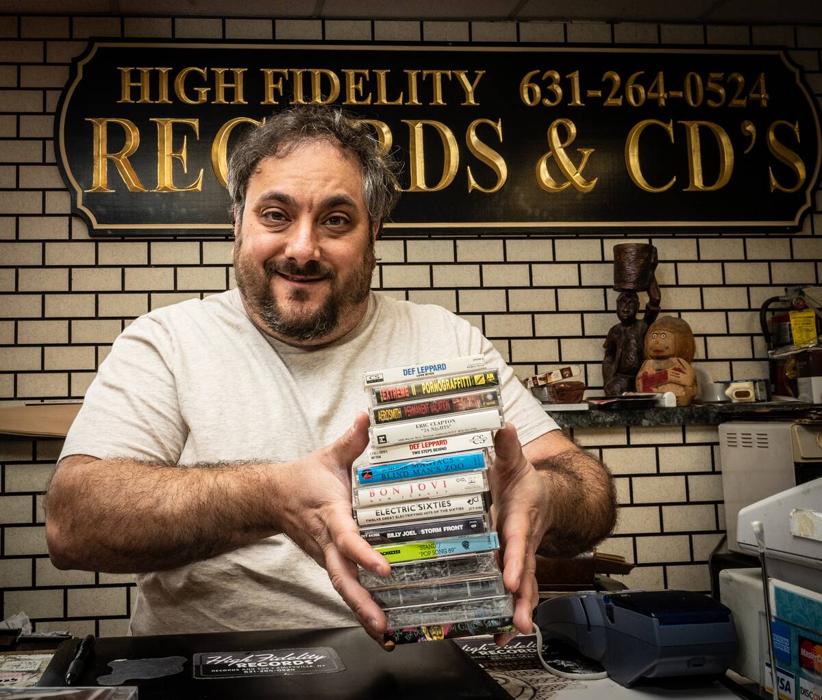 Owner of a Record Store on Long Island Holds Cassette Taoes