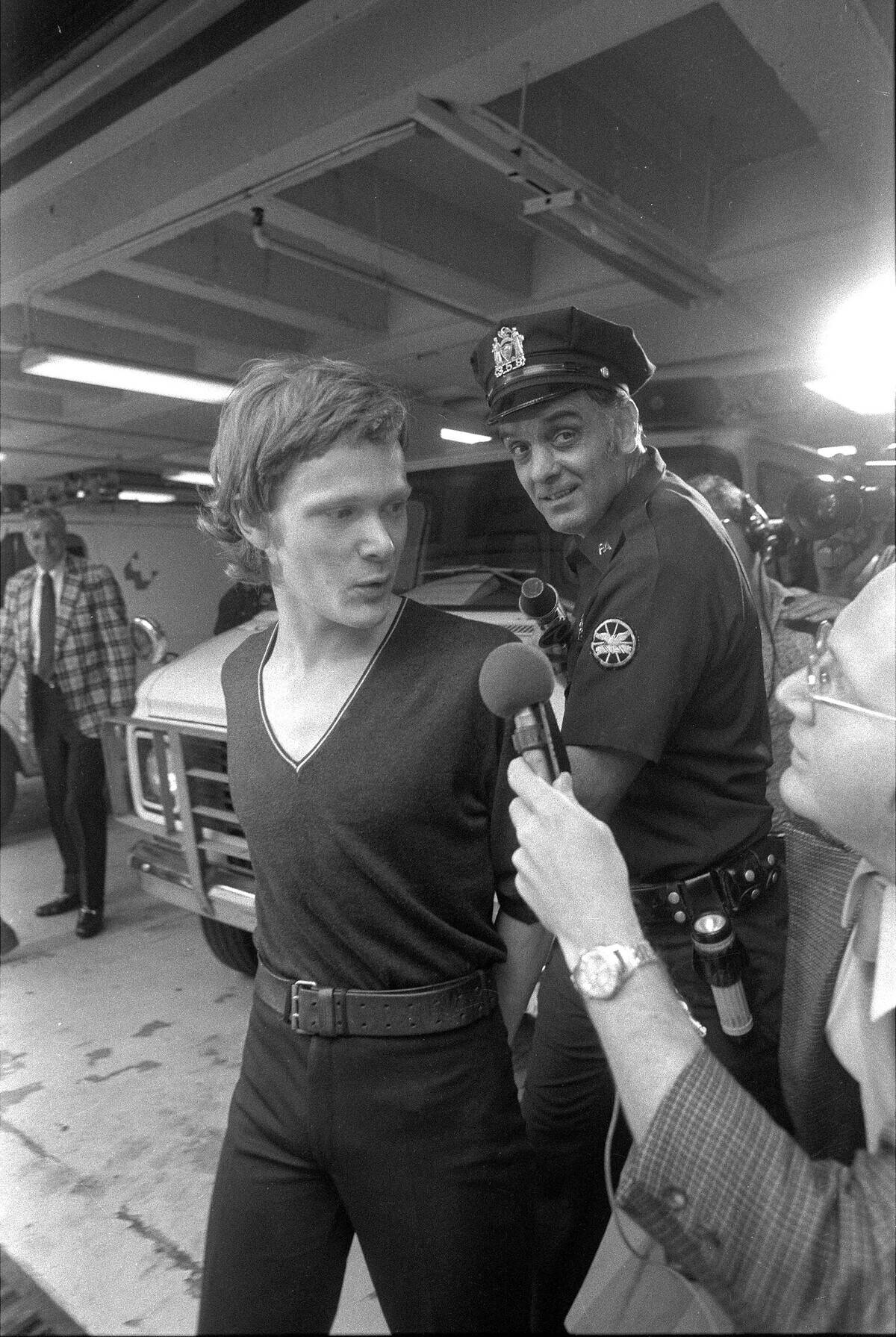 Philippe Petit (center) answers reporter's questions as he i