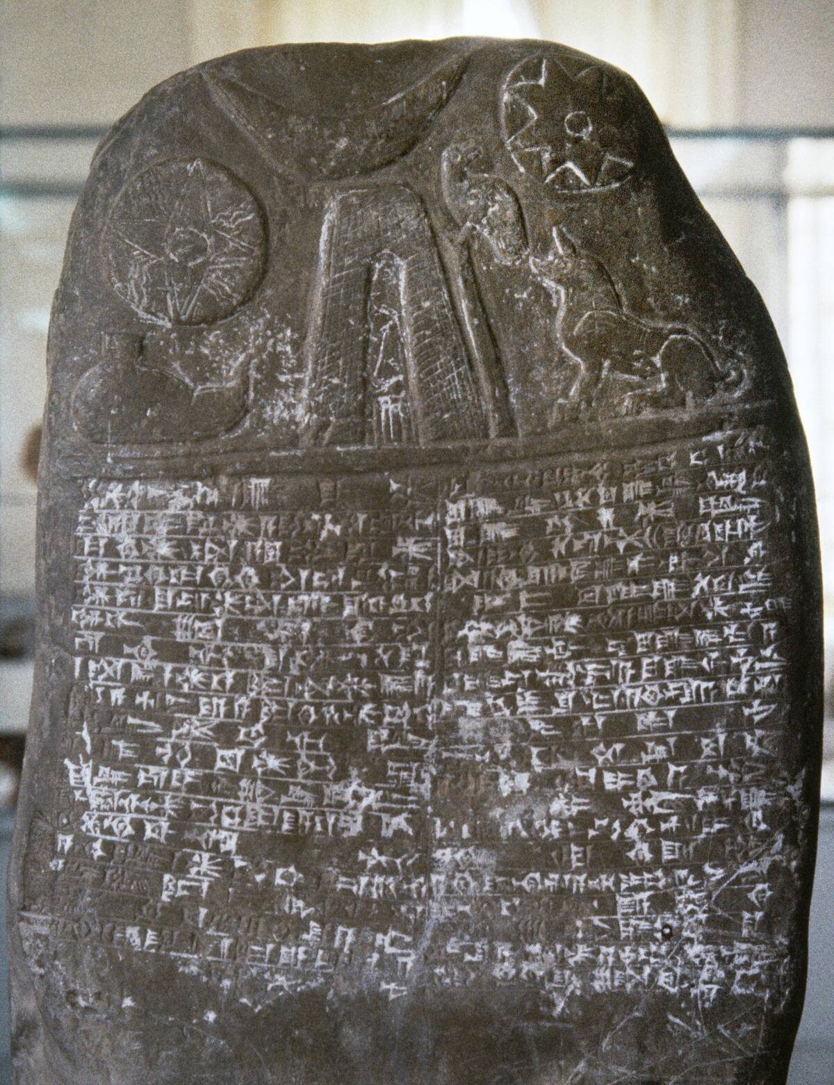 Stele, Babylonian origin. Sun, moon and water reliefs with cuneiform writing. 3000 BC.