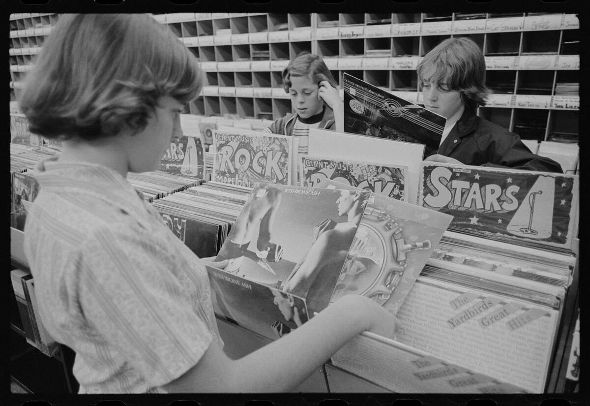 Teens Browse LPs At A Record Store