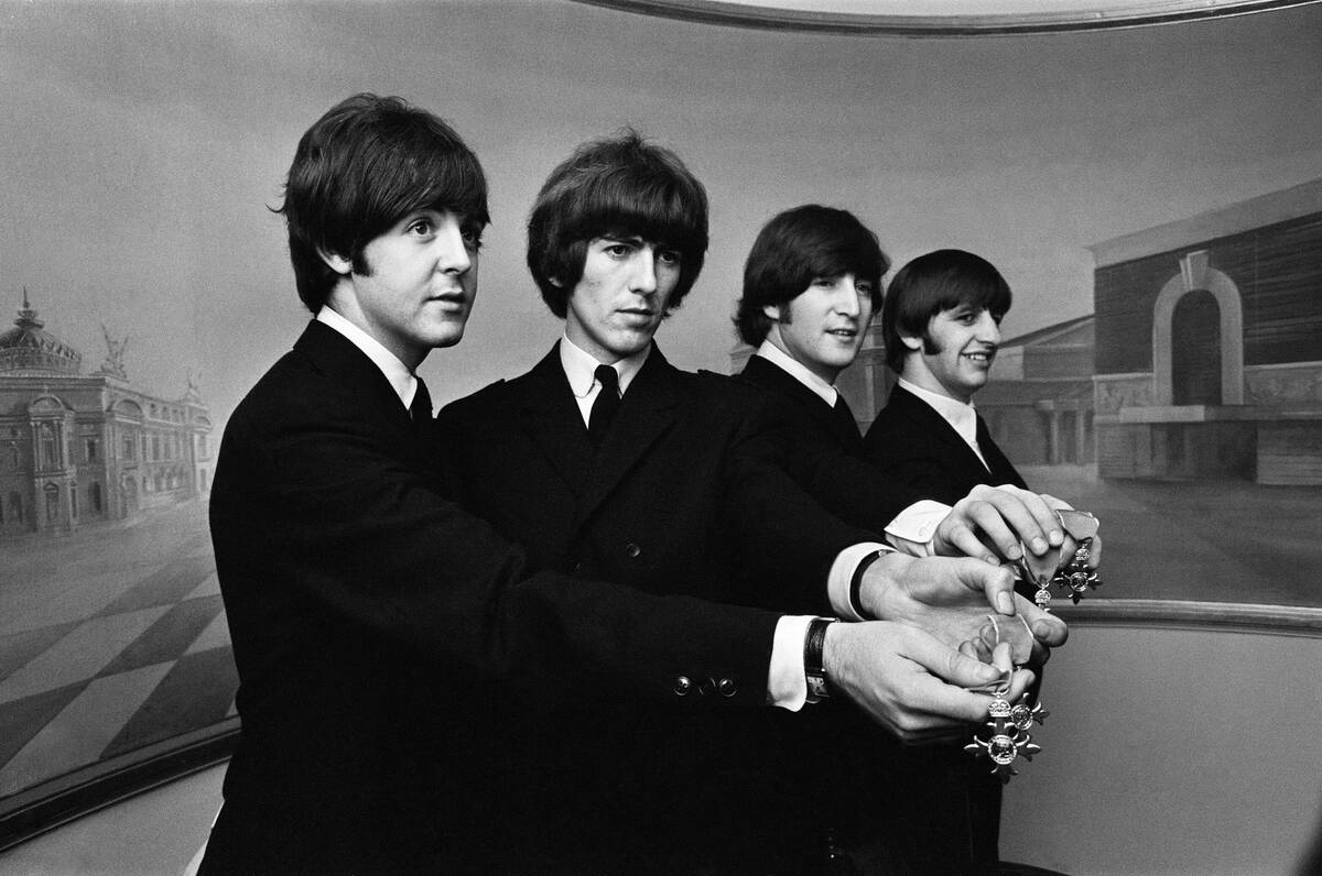 The Beatles show off their MBE medals at Buckingham Palace 1965