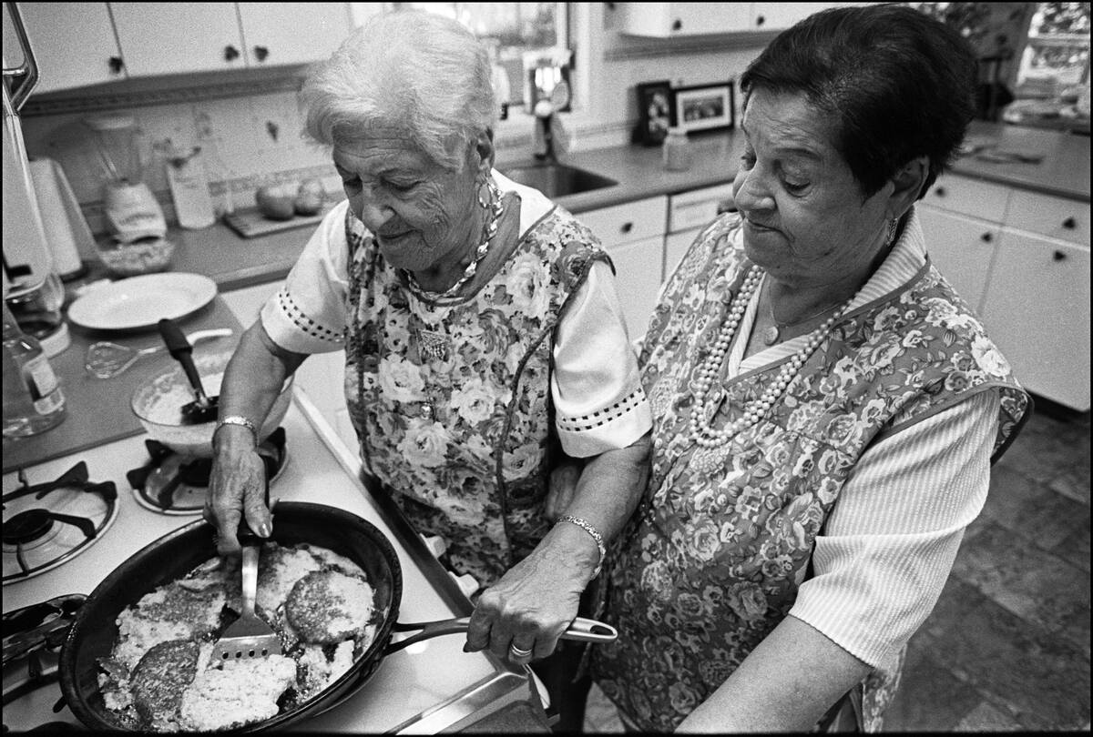 Two Sister Make Latkes In A Kitchen