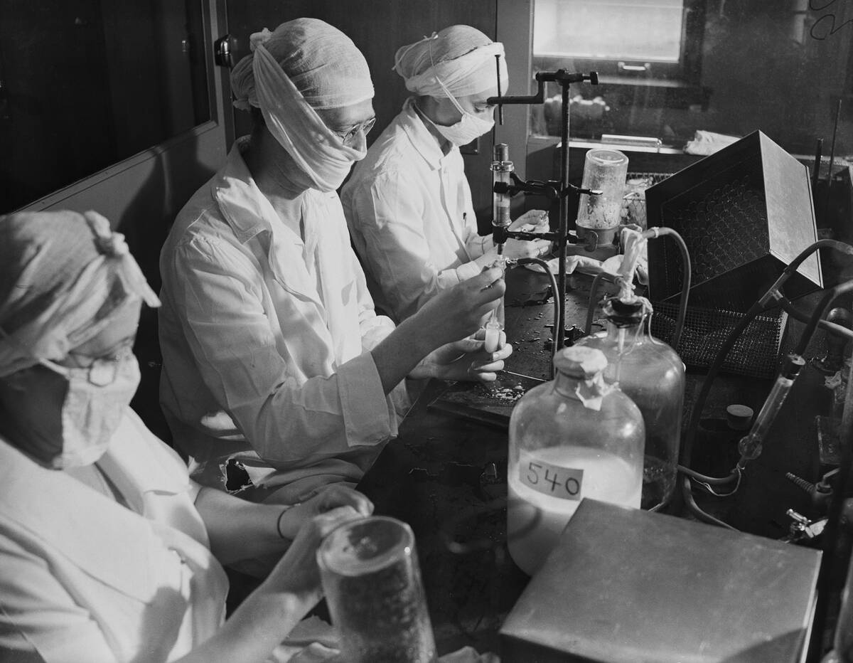 Women Wear Masks In Lab; Fill Vials