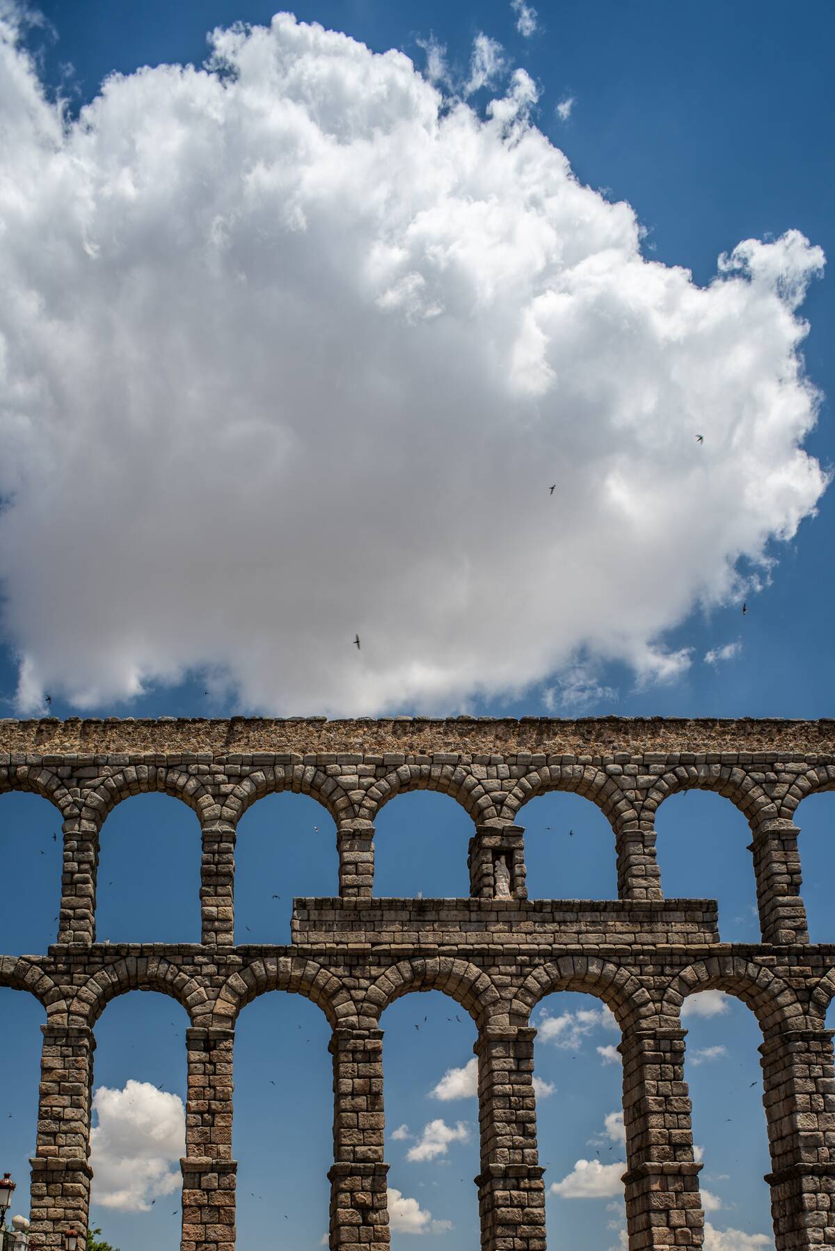 Ancient Roman Aqueduct in Segovia Under a Cloudy Sky