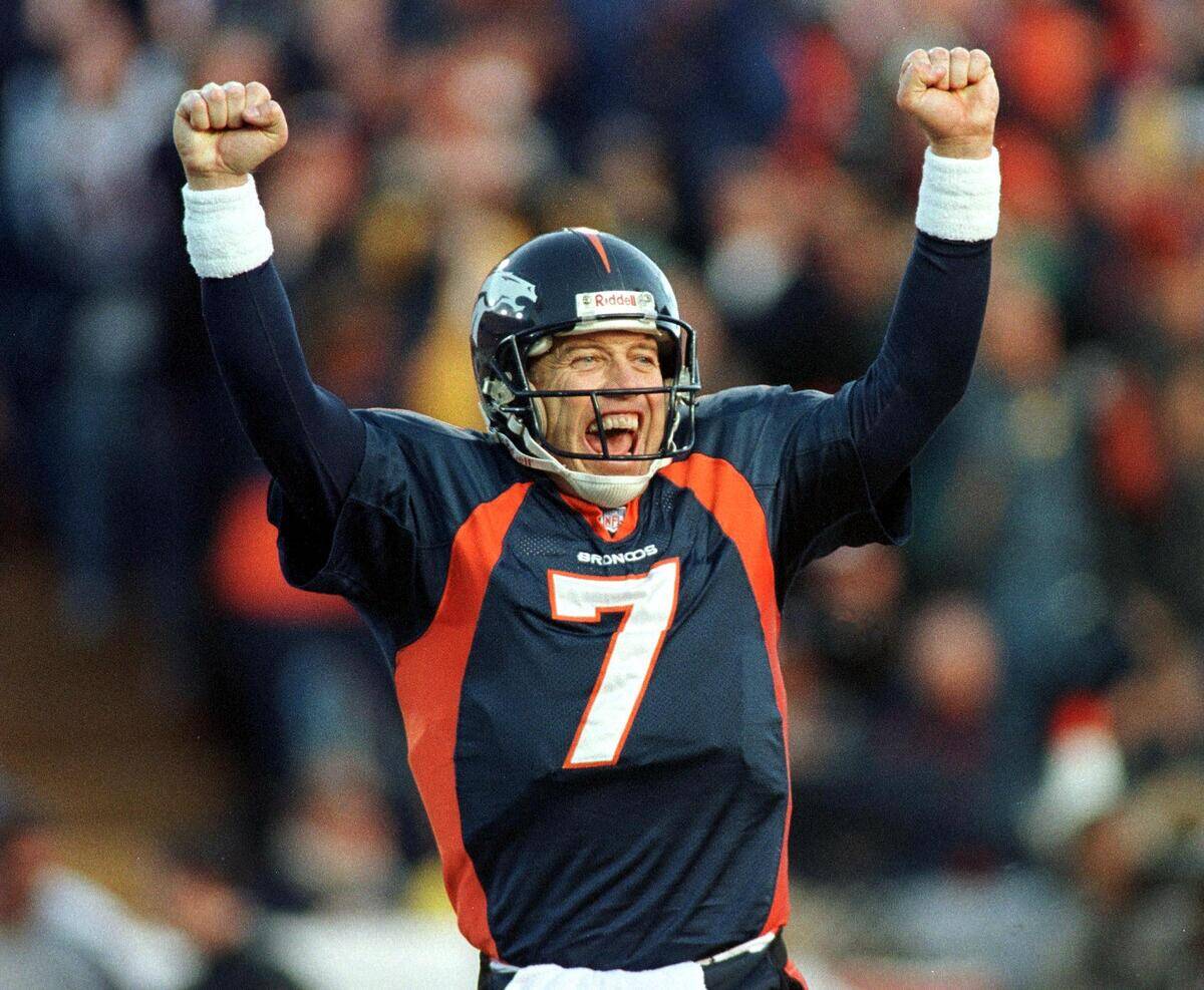 Denver Broncos quarterback John Elway celebrates a