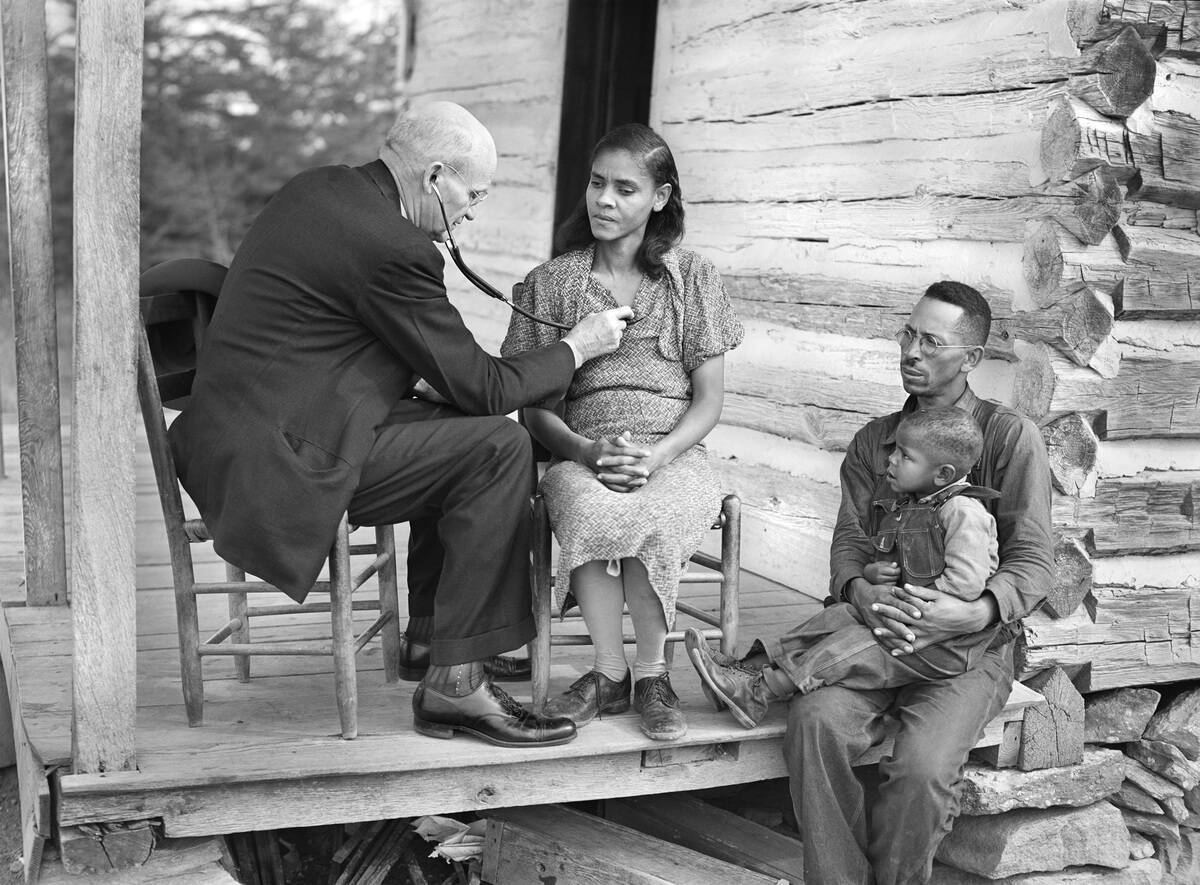 Doctor examining Farmer's Family on Front Porch, Caswell County, North Carolina, USA, Marion Post Wolcott, U.S. Farm Security Administration, October 1940