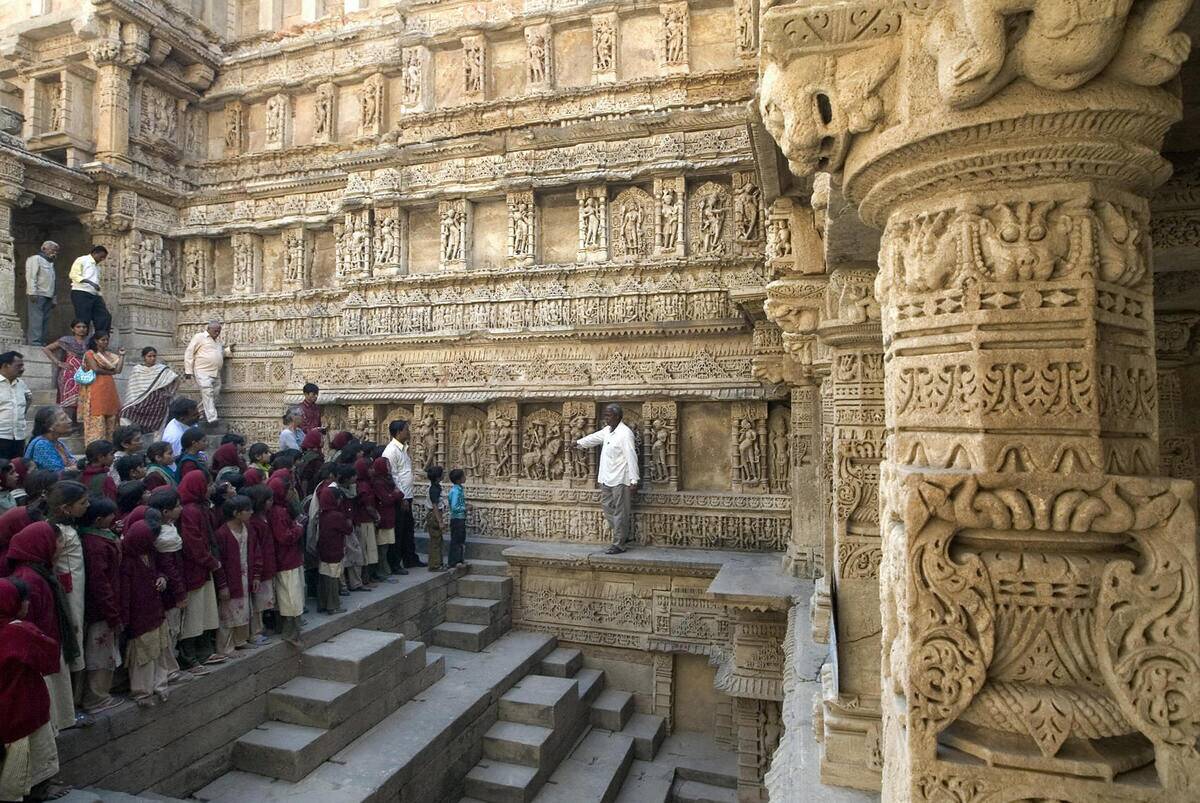 Indian schoolchildren listen as a guide