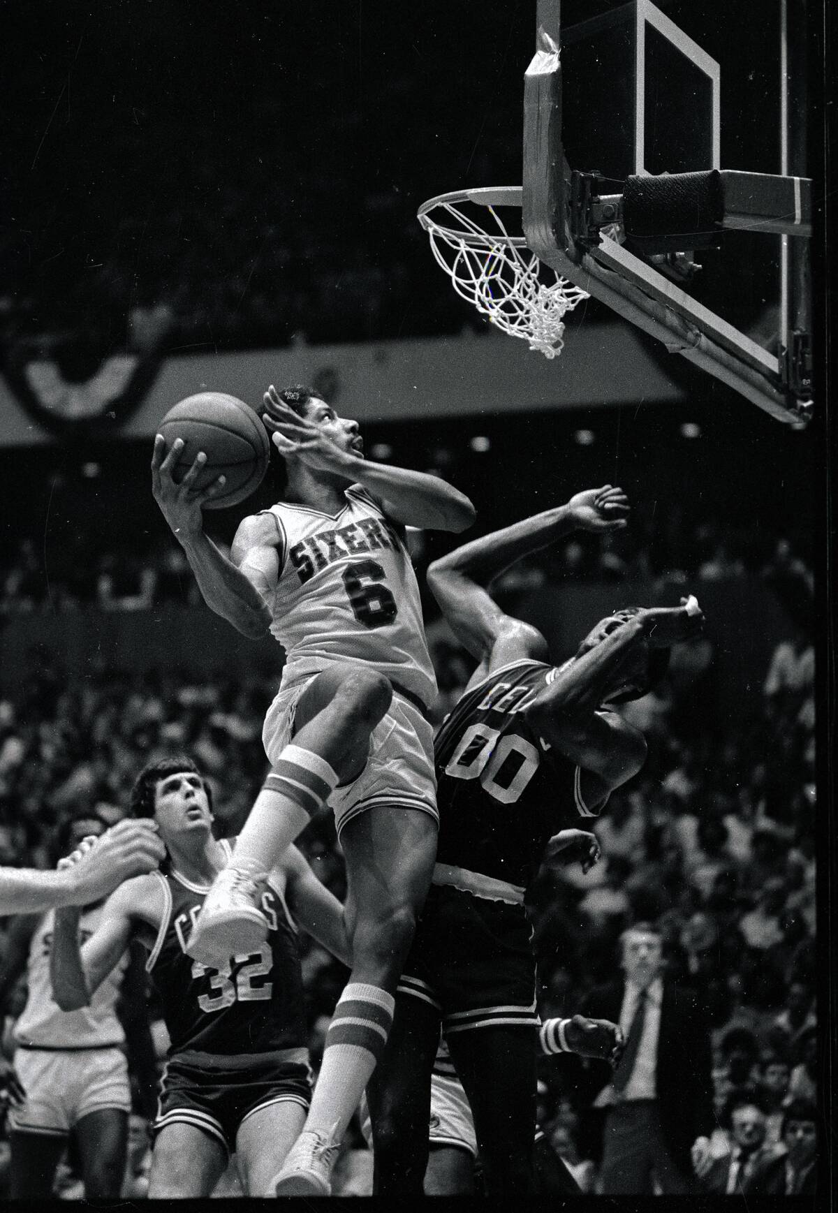 Julius Erving Crashing Into Opponent as He Tries to Score