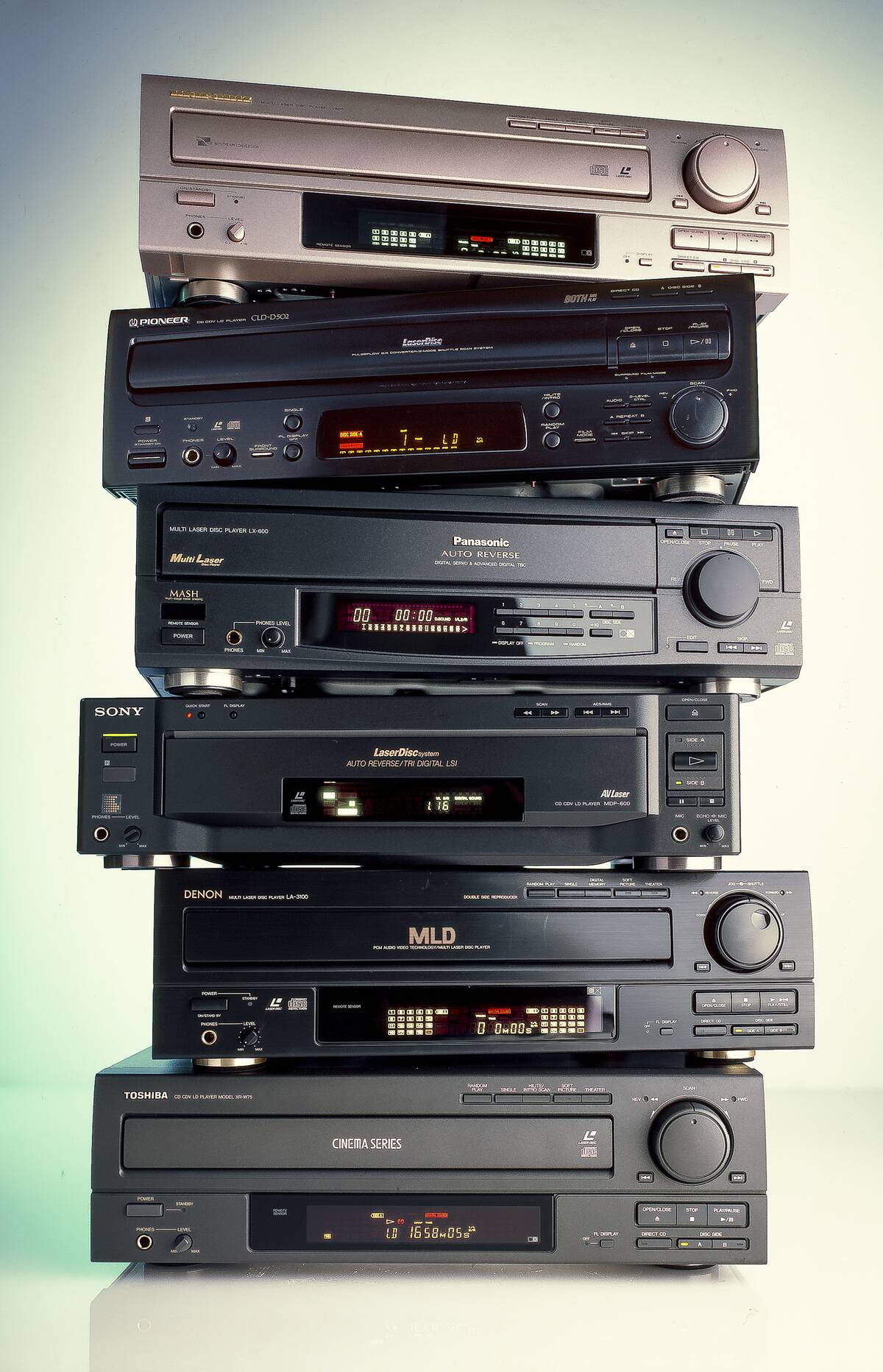 Six DVD players stacked atop each other