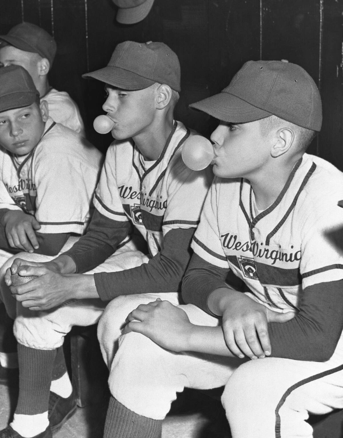 Little League Players Blowing Bubble Gum in Dugout
