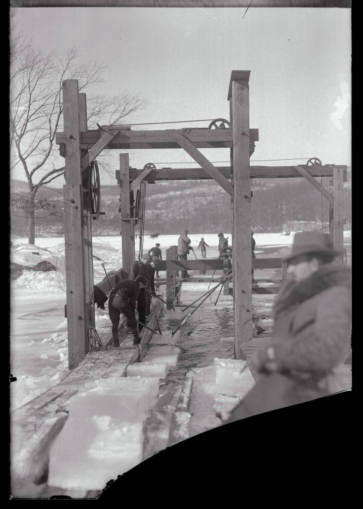 Men Gathering Ice from Frozen Pond