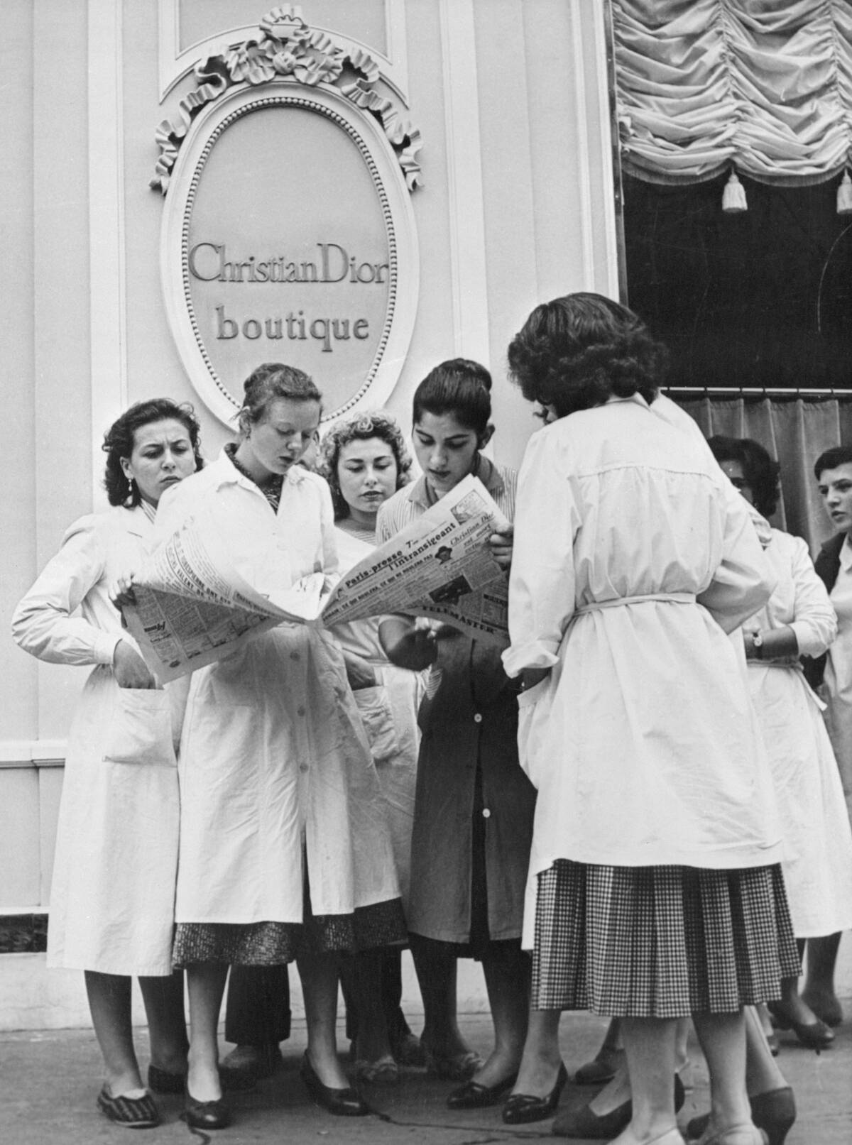 Midinettes Reading About Death of Christian Dior