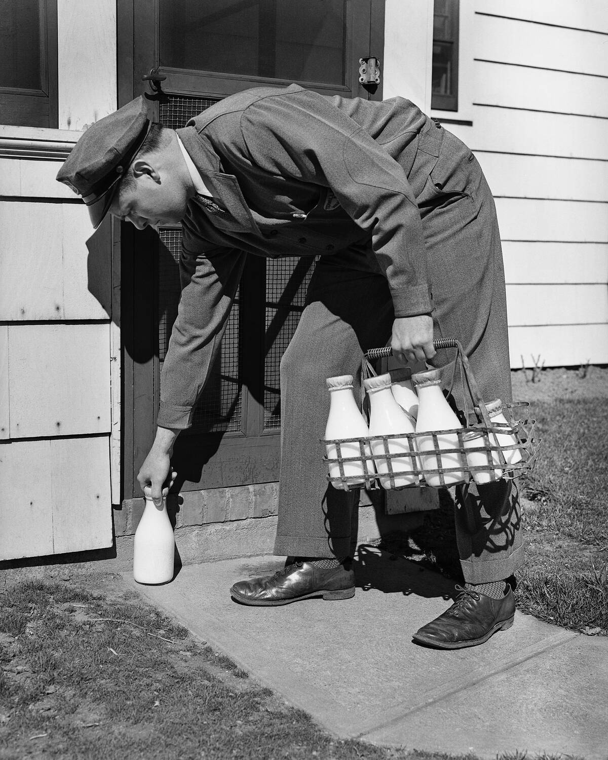 Milkman Leaving Milk Bottle on Doorstep
