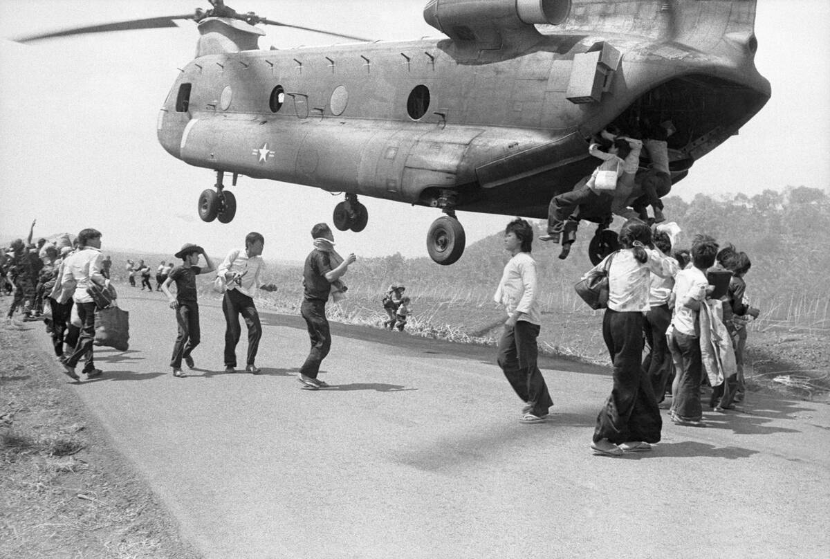 Refugees Hanging on to a Supply Helicopter