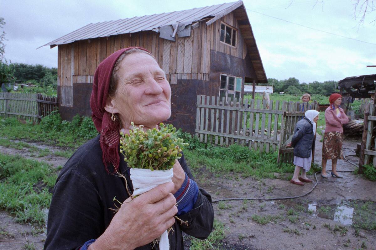 Russian Woman Holding a Plant Bouquet